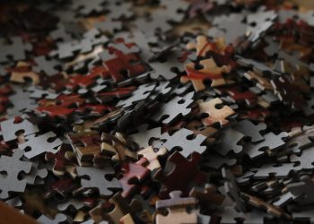 A detailed view of various colored puzzle pieces forming a complex pattern.
